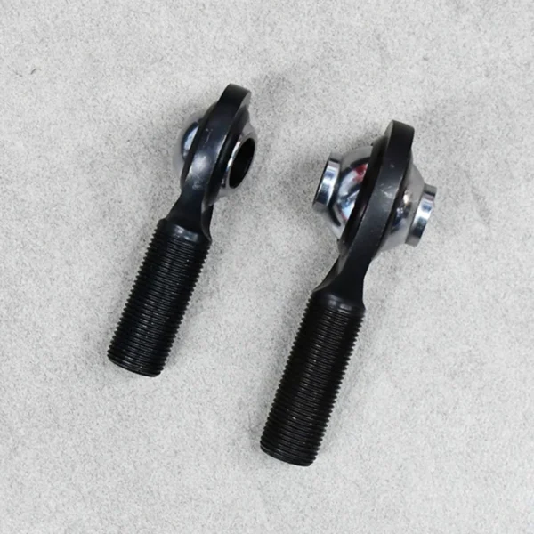 Side view of two black high-misalignment rod ends (PCM and PCYM) for enhanced suspension movement.