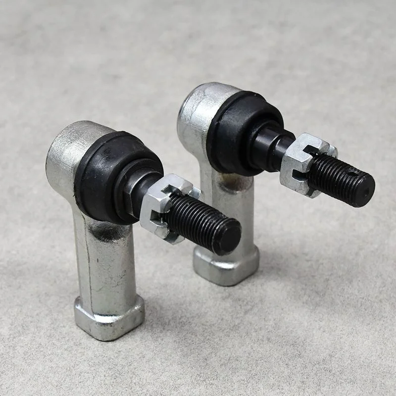 Two tie rod ends standing upright, designed for suspension systems.