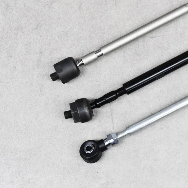 Close-up of three rack ends used in steering and suspension systems.
