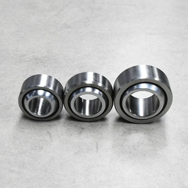 Display of three spherical plain bearings in a row, ideal for suspension applications.