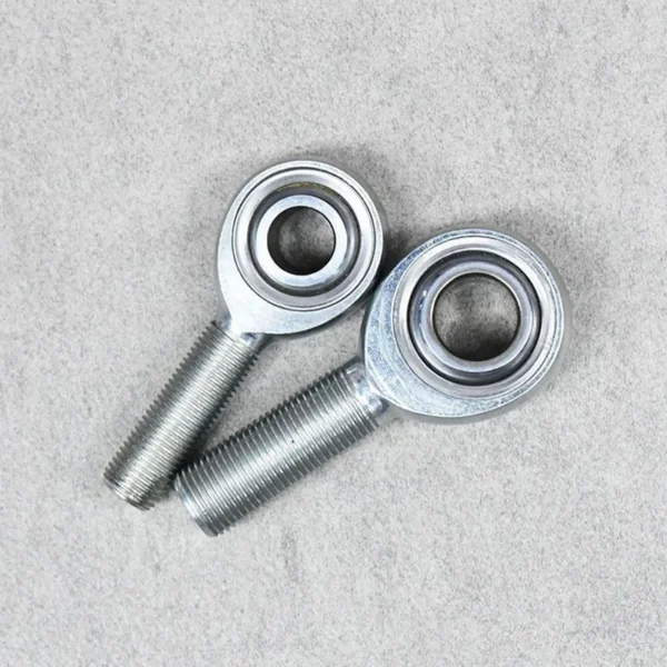 A pair of JMX male rod ends designed for suspension and steering systems.