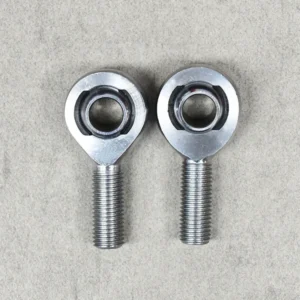 A pair of XM series heim joints, designed for precision suspension and steering systems.