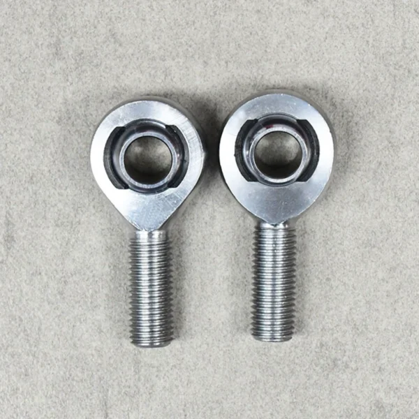 A pair of XM series heim joints, designed for precision suspension and steering systems.