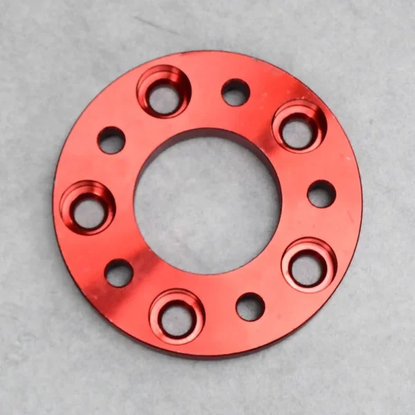 Red aluminum wheel spacer designed for enhanced wheel fitment and performance.