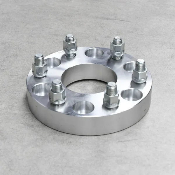 Silver aluminum wheel spacer designed for better vehicle handling and stability.