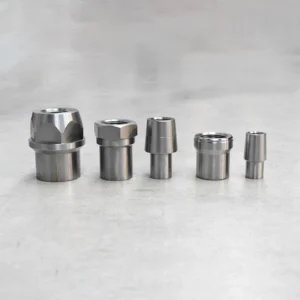 Five rod end tube adapters standing in a line, used for suspension and steering.