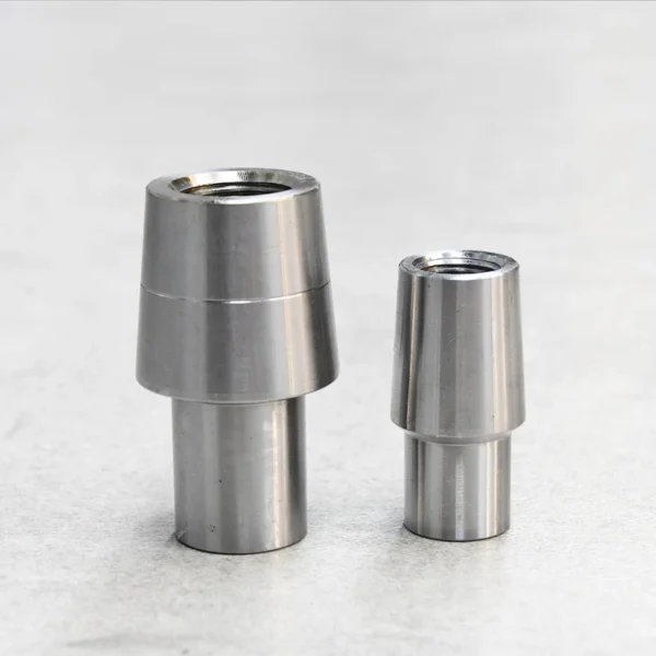 Two round rod end tube adapters designed for suspension components.