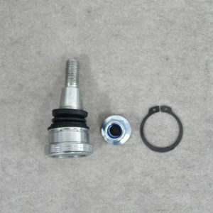 Close-up display of a new structure ball joint with heavy-duty chromoly housing for off-road vehicles.