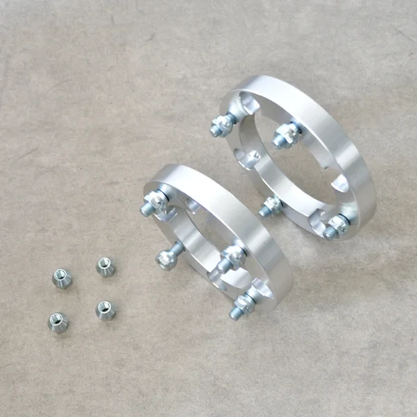 Two Polaris wheel adapters and nuts, designed for improved wheel fitment and stability.