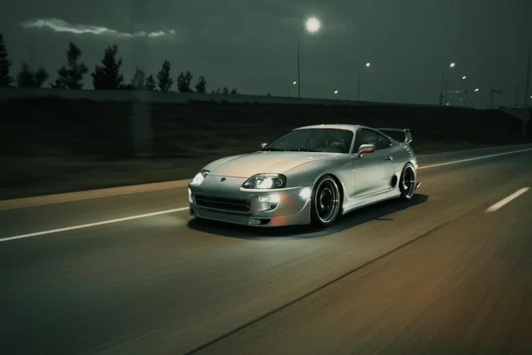 Toyota Supra driving at high speed on the road.