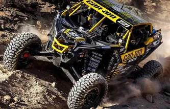 Can-Am UTV driving over rocky desert terrain
