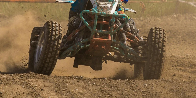 ATV drifting through dirt terrain.