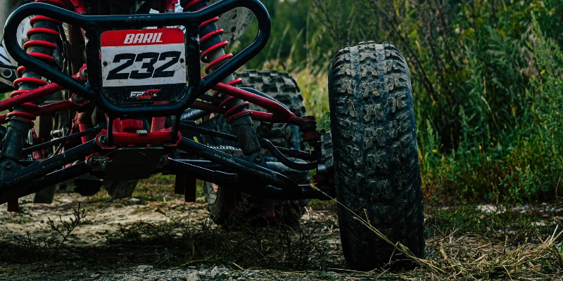 Close-up of ATV front suspension system.
