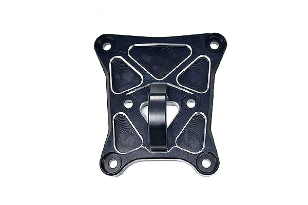 Square black metal mounting plate with four corner holes and a central clamp lever; appears to be a mounting/bracket component.