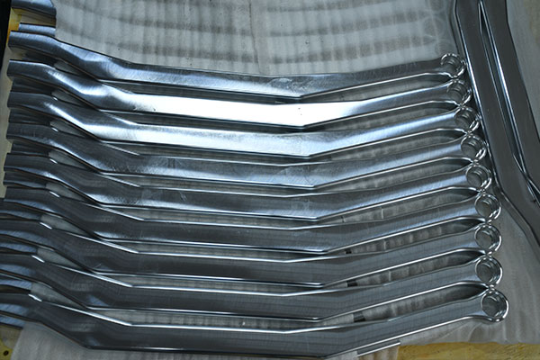Stack of metal wrenches laid in parallel, showing box-end rings on one side